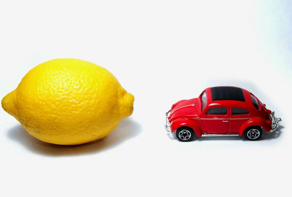 Small toy car next to lemon